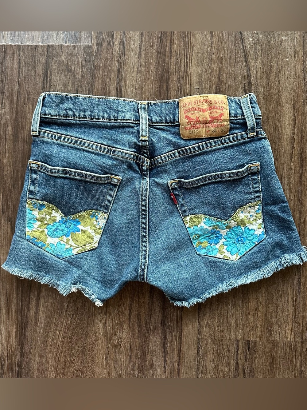 Upcycled Levi’s 511 Cut Off Shorts with Embroidered Pockets. Size 28; Runs Small